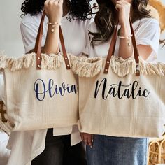 two women are holding large bags with personalized names