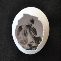 a white plate with an image of two people in it on a black tablecloth