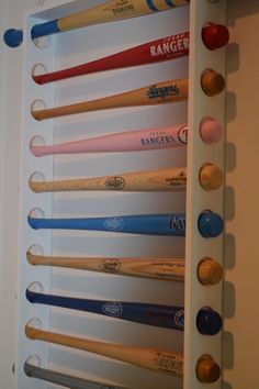 the baseball bats are lined up on the wall