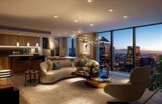 a living room filled with furniture and tall buildings in the background at sunset or dawn