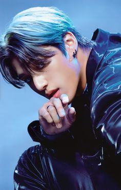 a young man with blue hair and piercings