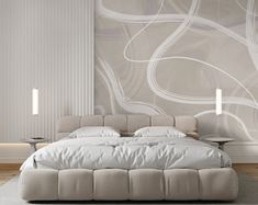 a large white bed sitting in a bedroom next to a wall