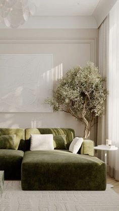 a living room with green couches and a tree in the corner on the wall