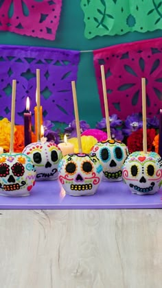 there are many sugar skulls with candles in the shape of skulls on top of them