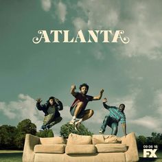 three men jumping on top of a couch in front of the words atlanta above them