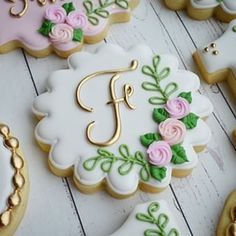 decorated cookies with the letter f on them are arranged in order to look like flowers and leaves