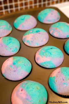 the muffins are covered in blue and pink icing