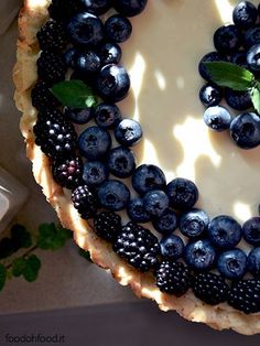 a pie with blueberries and blackberries on it