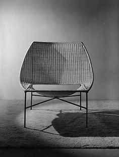 a white chair sitting on top of a carpet covered floor