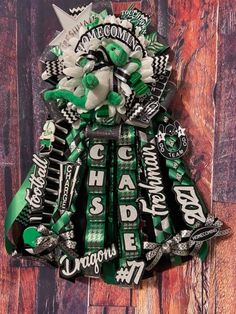 a bouquet made out of green and white candy bar wrappers on top of a wooden wall