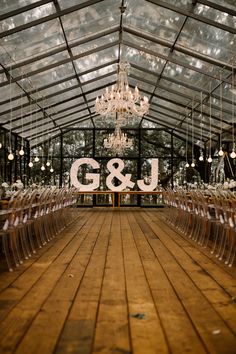 the inside of a building with chairs and chandeliers hanging from it's ceiling