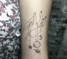 a woman's arm with a tattoo on it and an image of the planets