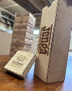 a cardboard box sitting on top of a wooden table next to stacks of boxes that are stacked