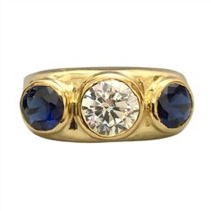 Elevate your style with this stunning Bezel Set Blue Sapphire CZ Diamond 3 Stone Ring. Crafted with a 14k yellow gold finish on 925 sterling silver, the vibrant blue sapphire combined with dazzling CZ diamonds creates a striking contrast, making it a timeless and versatile piece that will surely make a statement by adding a touch of sparkle to any outfit. This exquisite ring exudes elegance and sophistication, combines elegance and glamour effortlessly, and is a must-have for your jewelry collection. It is perfect for adding a touch of glamour to any outfit, making it the perfect accessory for any special occasion or as a thoughtful gift for a loved one. The Ring is made of 925 Sterling Silver set with Simulants of Blue Sapphire ( CZ)  and Diamond ( CZ)  ( Man Made Imitations) ,Main stones Classic Gold Three-stone Sapphire Ring, Luxury Gold Three-stone Sapphire Ring, Classic Gold Three Stone Sapphire Ring, Classic Gold Sapphire Ring With Three Stones, Gold Sapphire Three Stone Jewelry, Gold Sapphire Jewelry With Three Stones, 3 Stone Ring, Sapphire Rings, 3 Stone Rings