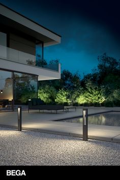 an outdoor area with lights and benches at night