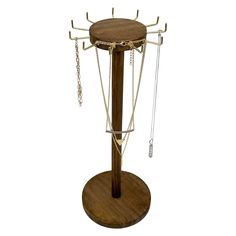 a wooden stand with several chains on it