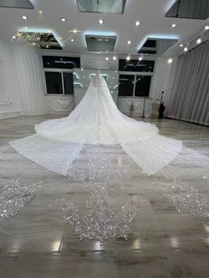 a white wedding dress is on display in a large room