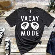 a t - shirt with the words vacay mode on it next to some shoes