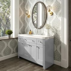 a bathroom with a vanity, mirror and window