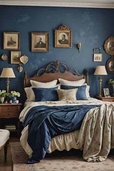 a bedroom with blue walls and pictures on the wall above the bed, along with two lamps