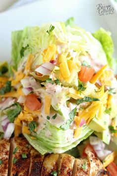 grilled chicken, lettuce and tomato salad on a plate with toothpicks