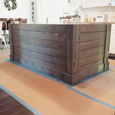 a wooden counter sitting on top of a hard wood floor