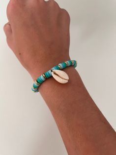 It is one of my favorite summer bracelets. It's perfect for the beach and will hold all year long. It has three shades of this beautiful blue, it also includes a gold embellishment, and a shell. Blue Bohemian Stretch Bracelet For Summer, Bohemian Blue Stretch Bracelet For Summer, Turquoise Summer Jewelry For Beach Season, Summer Turquoise Jewelry For Beach Season, Blue Beachy Jewelry For Vacation, Turquoise Coastal Jewelry For Beach, Summer Blue Jewelry For Beach Season, Ocean-inspired Strand Bracelets For Vacation, Beachy Shell Beaded Bracelets For Beach Season