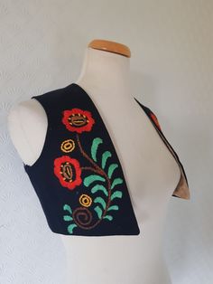 This is an antique traditional Norwegian bunad (Norwegian folk costume) bodice top or vest . It is most likely from the Telemark region and I think it is made between 1880 and 1920s. The bodice has been made with a black wool fabric and has been embroidered with beautiful floral rosemaling pattern . It is lined with a shiny patterned beige cotton(?). It is handmade and partially hand sewn. It is small and probably made for a child. The fabric is sturdy and it can be worn. It has  a tiny hole in Norwegian Folk Costume, Traditional Norwegian Clothing, Black Wool Fabric, Folk Vest, Norwegian Clothing, Norwegian Bunad, Rosemaling Pattern, Norwegian Christmas, Dresses Traditional