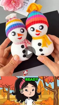 someone is holding two snowmen in their hands