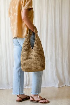 a person standing with a bag in their hand