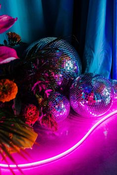 disco balls and flowers are lit up in the dark