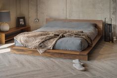 a bed sitting on top of a wooden platform in a bedroom