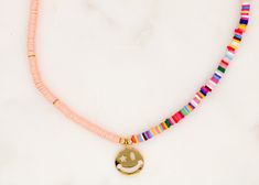 Handcrafted with Love Choker Multicolor Vinyl Disc Beads with 24K Gold-Plated with Smiley Zirconia Pendant Length: 14.5" with 2" Adjustable. Made in Colombia Fun Pink Beaded Necklaces With Letter Beads, Pink Letter Beads Fun Necklaces, Playful Pink Necklaces For Festivals, Pink Jewelry With Gold Beads For Festival, Playful Pink Necklace For Festival, Playful Pink Festival Necklaces, Pink Gold Beaded Jewelry For Festival, Fun Pink Beaded Necklaces For Gifts, Playful Pink Necklace With Colorful Beads