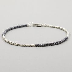 This hematite bracelet is half sterling silver beads.  The pattern is interesting to wear alone as a minimalist bracelet or an addition to your stacking bracelet collection.  The gray is easily worn along side other colors, as is the silver.   Neutral colored jewelry is always a welcomed addition.   Hematite has a grounding energy without lowering your overall energy.  Afterall, you want to keep your energy levels as high as you can. 2mm round hematite beads 2mm round sterling silver beads sterl Silver Necklace Designs, Necklaces Ideas, Custom Necklaces, Hematite Jewelry, Silver Jewelry Diy, Hematite Bracelet, Jewelry Minimalist, Jewelry Beaded, Jewellery Ideas