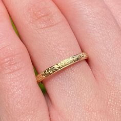 a woman's hand with a gold ring on it