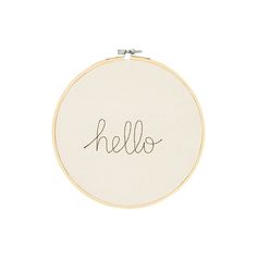 a hand embroidered hoop with the word hello in cursive writing