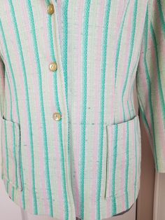 "Cute little blazer style jacket. The fabric is a poly knit that has shades of green and pink stripes. Kinda reminds me of a watermelon! Has two patch pockets on the front, and 3 buttons. Label read, \"West Coast Fashions California\" Condition: Fair to good, but definitely wearable! There is a bit of verall pilling, and a few pulls in the fabric, which isn't that noticeable. Measurements Bust: up to 41\" Length: 23\"" Green Spring Blazer With Buttons, Spring Green Blazer With Buttons, Green Blazer With Buttons For Spring, Spring Striped Outerwear With Button Closure, Retro Green Blazer For Spring, Green Summer Outerwear With Buttons, Spring Striped Buttoned Outerwear, Striped Buttoned Outerwear For Spring, Vintage Striped Spring Outerwear