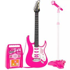 a pink electric guitar and microphone next to it's case on a white background