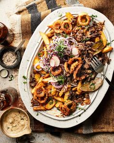 a white plate topped with fries and onions