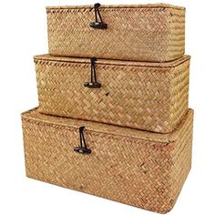 three woven storage baskets stacked on top of each other with black handles and latches