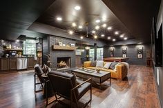 a living room filled with furniture and a fire place in the middle of a room