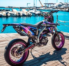 a motorcycle parked on top of a wooden dock