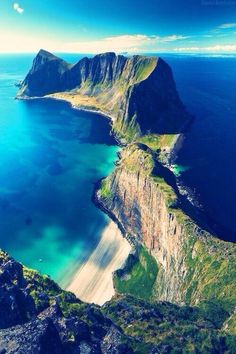 an aerial view of the ocean and mountains