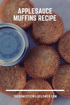 some muffins are sitting next to a jar with the words applesauce muffins recipe on it