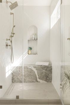 a walk in shower sitting inside of a bathroom