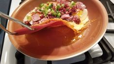 a plate with some food on it sitting on a stove top next to an oven