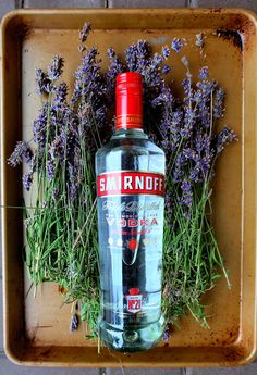 a bottle of smirnoff vodka with lavender sprigs on the side