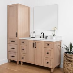 a bathroom vanity with two sinks and wooden cabinets