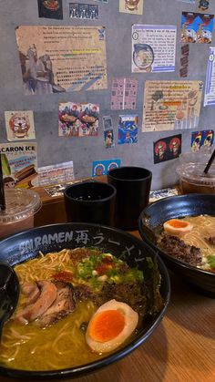 two bowls of ramen are sitting on a table