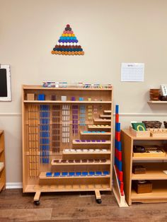 a child's play room with wooden shelves and toys on the floor in front of it